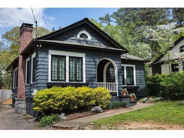 Charming home featuring updated trim and landscaping, with a brick chimney and covered entry at 2800 Memorial Se Dr, Atlanta, GA 30317