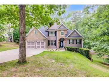 Charming home with a stone and siding exterior, two-car garage, and beautifully landscaped front yard at 1058 Magnolia Dr, Villa Rica, GA 30180