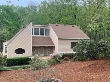 Charming two-story home featuring manicured landscaping and unique architectural details nestled among mature trees at 4487 Park Place Ter, Marietta, GA 30066