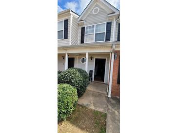 Traditional-style home featuring vinyl siding and manicured shrubbery around the front entrance at 930 Parkway Rd, Union City, GA 30291