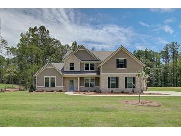 Inviting two-story home featuring manicured landscaping and a charming light blue front door at 21 Homesite Cooper E Cv, Fayetteville, GA 30215
