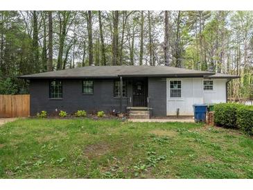 Cozy one-story home with a dark painted brick facade and front lawn at 2191 Camp Ground Rd, Atlanta, GA 30331