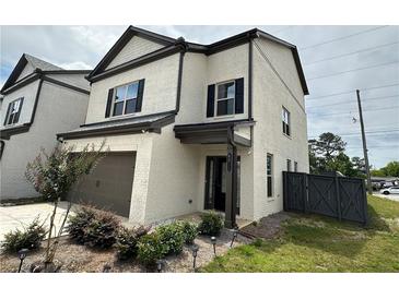 Two-story painted brick home with a single-car garage, black shutters, and a landscaped front yard at 4215 Almanor Cir, Norcross, GA 30071