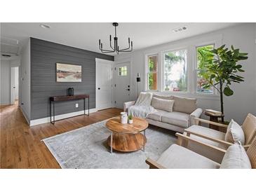 Bright living room with hardwood floors, modern lighting, and stylish decor at 912 Fairburn Nw Rd, Atlanta, GA 30331