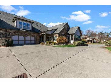 Charming home with a two-car garage, beautiful brickwork, and well-manicured landscaping at 120 Chastain Nw Rd # 608, Kennesaw, GA 30144
