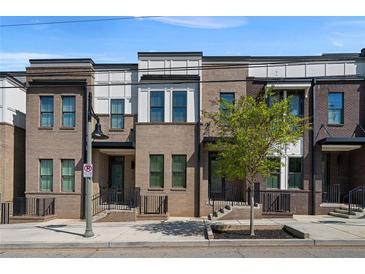 Modern brick townhome featuring a well manicured lawn and inviting front entrance at 2614 Talley St, Decatur, GA 30030