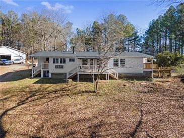 Ranch-style home with decks, situated on a treed lot with separate garage at 4941 N Helton Rd, Winston, GA 30187