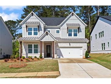 Charming two-story home with a well-manicured lawn, grey brick, and inviting curb appeal at 779 Keystone Dr, Woodstock, GA 30188