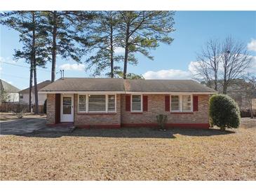 Charming single-story brick home with red shutters and a well-maintained front yard at 8554 Taylor Rd, Riverdale, GA 30274