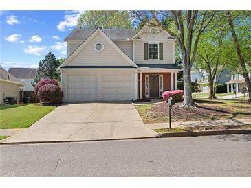 Charming two-story home with a two-car garage and well-maintained landscaping in a suburban neighborhood at 4070 Amber Leaf Dr, Roswell, GA 30076