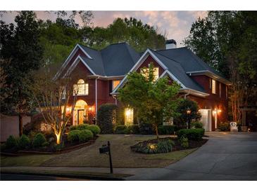Charming red brick home with a landscaped front yard, mature trees, and a cozy ambiance at 225 Cotton Field Ct, Alpharetta, GA 30022