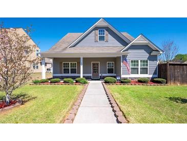 Charming home featuring manicured lawn and a welcoming walkway leading to the covered front porch at 416 Blue Sky Cir, Acworth, GA 30102