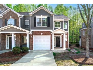 Charming two-story townhome with attached garage and well-manicured front yard in a desirable neighborhood at 2732 Pierce Brennen Ct, Lawrenceville, GA 30043