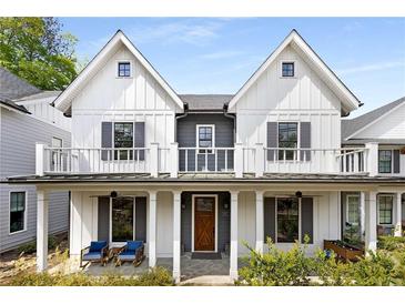 Charming two-story home with a covered front porch and balcony, offering inviting curb appeal at 1911 Commons Cir, Brookhaven, GA 30341