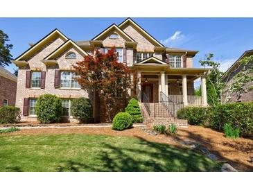 Beautiful two-story brick home with a well-manicured lawn and mature trees at 2141 Abby Ne Ln, Atlanta, GA 30345