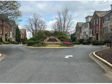 Street view of townhomes at The Gates at Parkside Village featuring beautiful landscaping and well-maintained exteriors at 611 Parkside Village Nw Way, Marietta, GA 30060