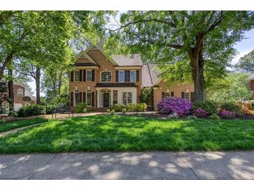 Beautiful brick home featuring a manicured lawn and lush landscaping at 131 Helmswood Sw Cir, Marietta, GA 30064