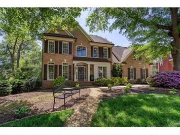 Charming two-story brick home featuring manicured landscaping and a welcoming front porch at 131 Helmswood Sw Cir, Marietta, GA 30064