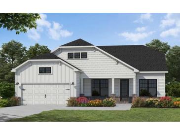 Charming two-story home featuring a symmetrical facade, attached garage, and professionally landscaped front yard at 341 Sobeck Way, Canton, GA 30115