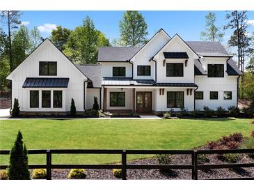 Beautiful two-story home featuring black frame windows and a meticulously manicured front lawn at 120 Farm Gate Dr, Woodstock, GA 30188