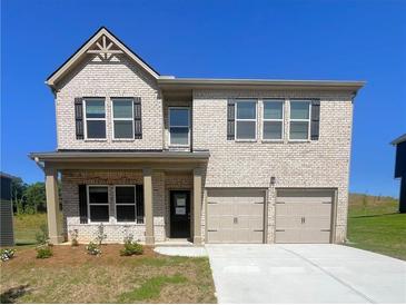 Two-story brick home featuring a two-car garage and classic black shutters at 678 Egrets Landing #63, Covington, GA 30014