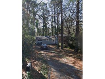 Cozy single-story home with brick accents and a private, tree-lined driveway at 2485 Ortega N Way, Chamblee, GA 30341