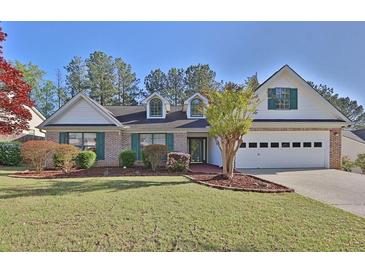 Charming single-Gathering home featuring a manicured front lawn, brick accents, and an attached two-car garage at 1112 Autumn Glen Way, Dacula, GA 30019