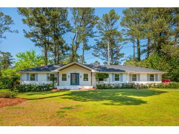 Charming, single-story home features a well-manicured lawn, classic brick exterior, and mature trees at 3365 Ardley Sw Rd, Atlanta, GA 30311