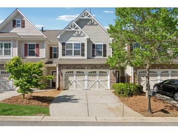 Charming townhouse with a two-car garage and attractive brick and siding exterior at 2894 Cross Creek Dr, Cumming, GA 30040