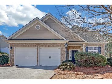 Charming single-story home with brick facade, two-car garage, and well-maintained landscaping at 5013 Centennial Commons Nw Dr, Acworth, GA 30102