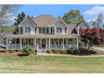 Charming two-story home with a welcoming front porch, manicured lawn, and lovely curb appeal at 60 Bartlett Way, Dallas, GA 30157