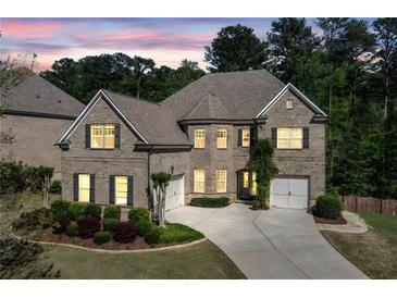 Charming brick home featuring manicured landscaping, attached two-car garage, and a well-maintained lawn at 2564 Walden Estates Dr, Marietta, GA 30062