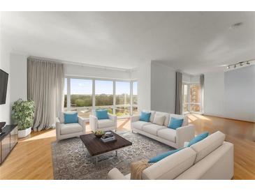 Bright living room featuring hardwood floors, large windows, and elegant furniture at 3475 Oak Valley Road Ne # 870, Atlanta, GA 30326