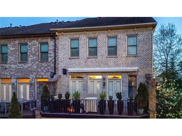 Charming rear exterior features a cozy balcony and manicured landscaping, offering a serene outdoor living space at 3663 Brookhaven Manor Ne Xing, Atlanta, GA 30319