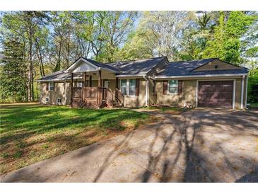 Charming single-story home with a inviting front porch and an attached garage at 1441 Cahaba Sw Dr, Atlanta, GA 30311