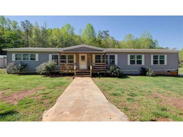 Charming single-story home with a covered front porch, inviting curb appeal and walkway leading to the front door at 537 Craven Rd, Roopville, GA 30170