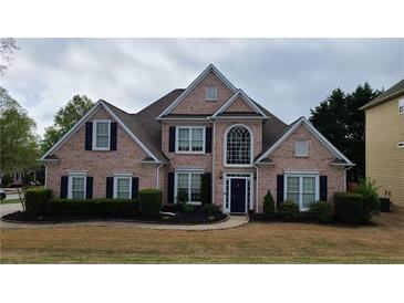 Beautiful brick home with a manicured lawn and dark shutters at 4118 Sandy Branch Dr, Buford, GA 30519