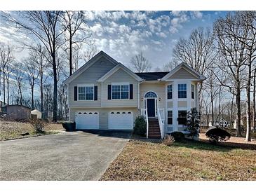 Charming two-story home featuring an attached two-car garage and a well-maintained front yard at 1550 Royale Castle Dr, Lawrenceville, GA 30043