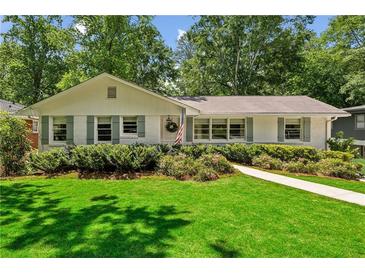 Charming single story home with a well-maintained front lawn and mature landscaping at 389 Valley Brook Ne Dr, Atlanta, GA 30342