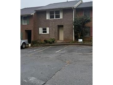 This townhome features a brick facade, white trim, and convenient parking at 4485 Golf Vista Cir, Decatur, GA 30035