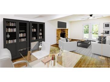 Bright living room featuring a brick fireplace, modern furniture, and built-in shelving for an inviting space at 1333 Briar Ridge Ln, Jonesboro, GA 30238