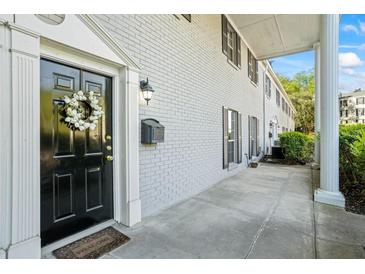 Charming exterior featuring a black front door with a decorative wreath and a covered entryway at 3689 Essex Ave # 16, Atlanta, GA 30339