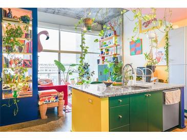 Stylish kitchen featuring colorful cabinetry, granite countertops, and ample natural light at 130 Arizona Ne Ave # 415, Atlanta, GA 30307