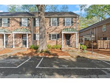 Brick townhouse with covered porch and parking in front at 6700 Roswell Rd # 20D, Sandy Springs, GA 30328