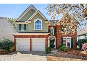 Charming two-story home with brick facade, well-manicured lawn, and a two-car garage at 1888 Fox Chapel Se Dr, Smyrna, GA 30080