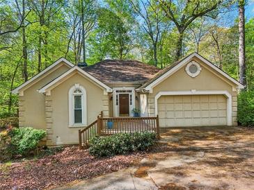 Attractive single-Gathering home with a well-manicured front yard and charming front porch at 230 Oakmere Dr, Alpharetta, GA 30009