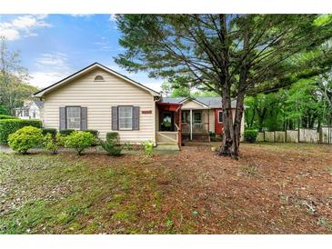 Charming single-story home featuring a cozy front porch and well-maintained landscaping at 2172 Oakland Ridge Dr, Lawrenceville, GA 30044