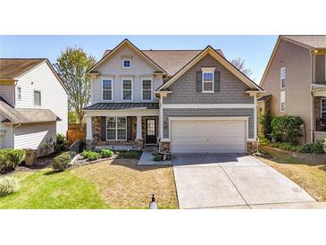 Charming two-story home with a well-manicured lawn and an attached two-car garage at 625 Lorimore Pass, Canton, GA 30115