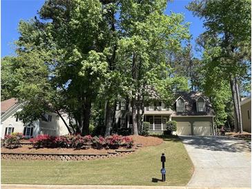 Charming home featuring a lush landscaped yard and a convenient two-car garage, inviting curb appeal at 863 Fairwood Pointe Nw, Acworth, GA 30101