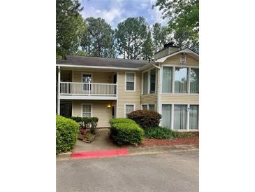 Inviting two-story condo with a balcony, landscaped entrance, and ample parking space at 1504 Augusta Se Dr, Marietta, GA 30067